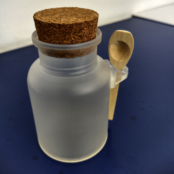 Frasco con cuchara de madera